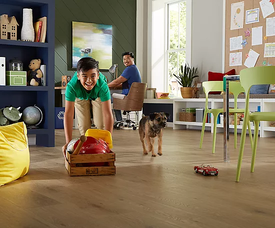 Happy kid playing with puppy | Thornton Flooring
